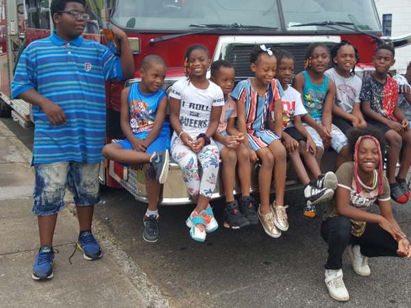 group image of kids sitting on firetruck