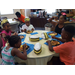 Five children eating waffles at restaurant