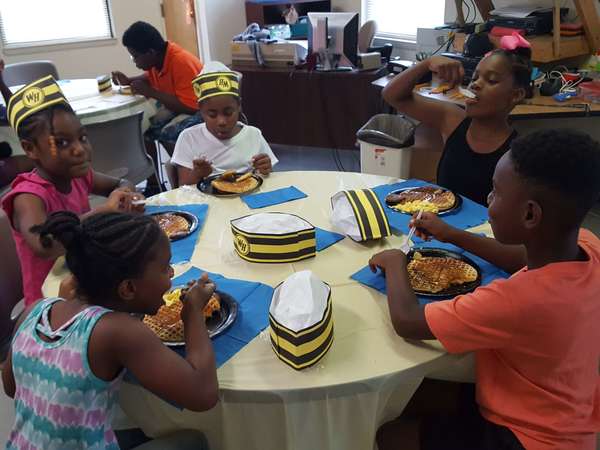 Five children eating waffles at restaurant