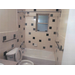 bathroom with bathtub shower and commode