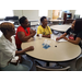 three female residents talking with female performing the HIV tests